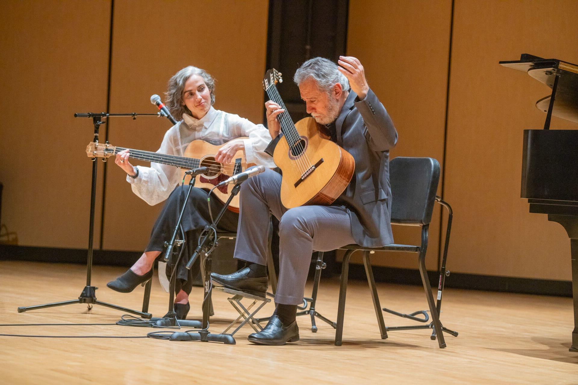 Musicians performing live with classical guitar and cello.